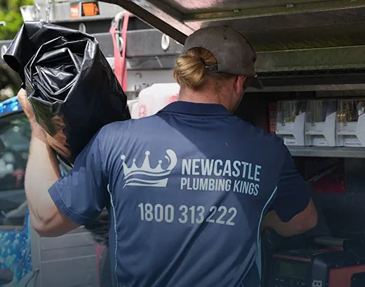 Plumber pulling fittings from the ute drawers